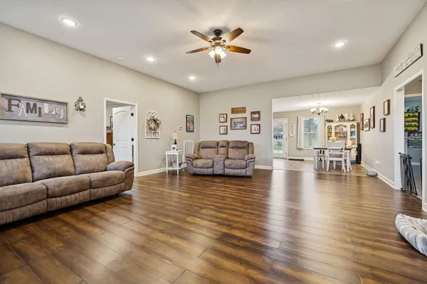 a living room with furniture and wooden floor