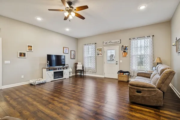 a living room with furniture and a flat screen tv