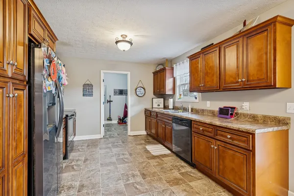 a kitchen with stainless steel appliances granite countertop a refrigerator and a stove top oven