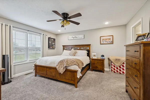 a spacious bedroom with a bed and a chandelier