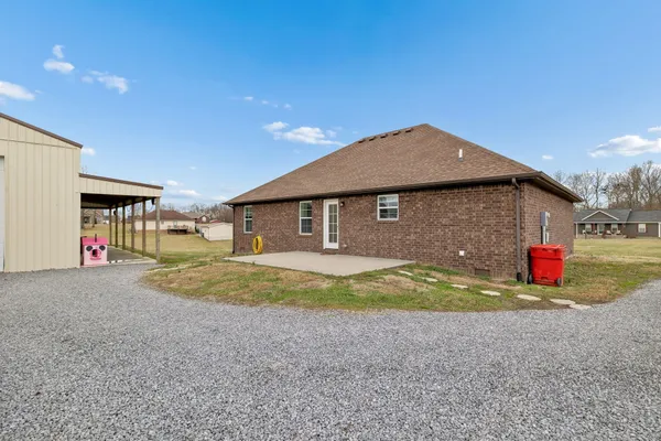 a view of the house with backyard and garage
