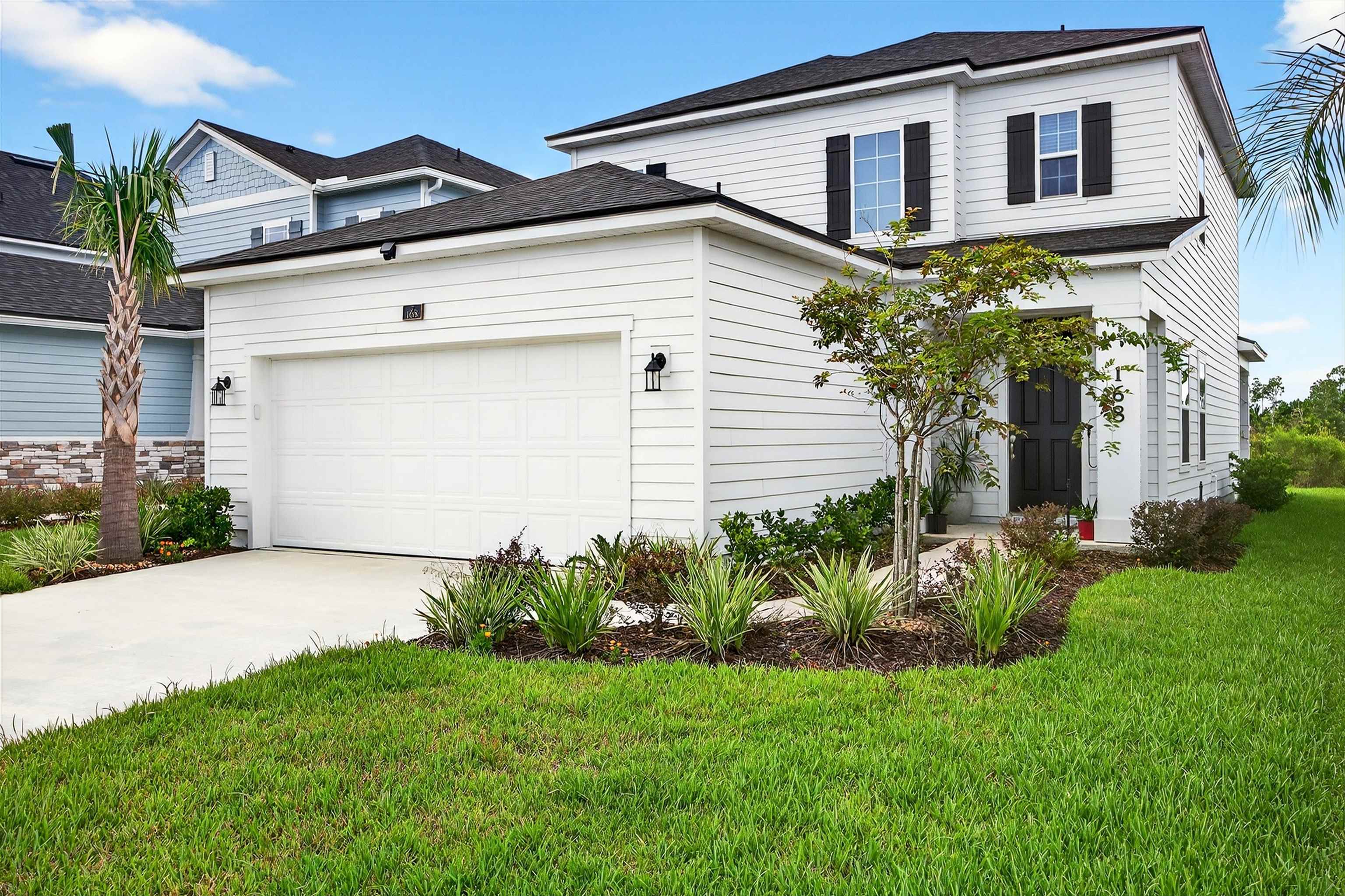 168 Torres Trace St. Augustine, FL 32095 - Photo 1 of 51 a front view of house with a garden