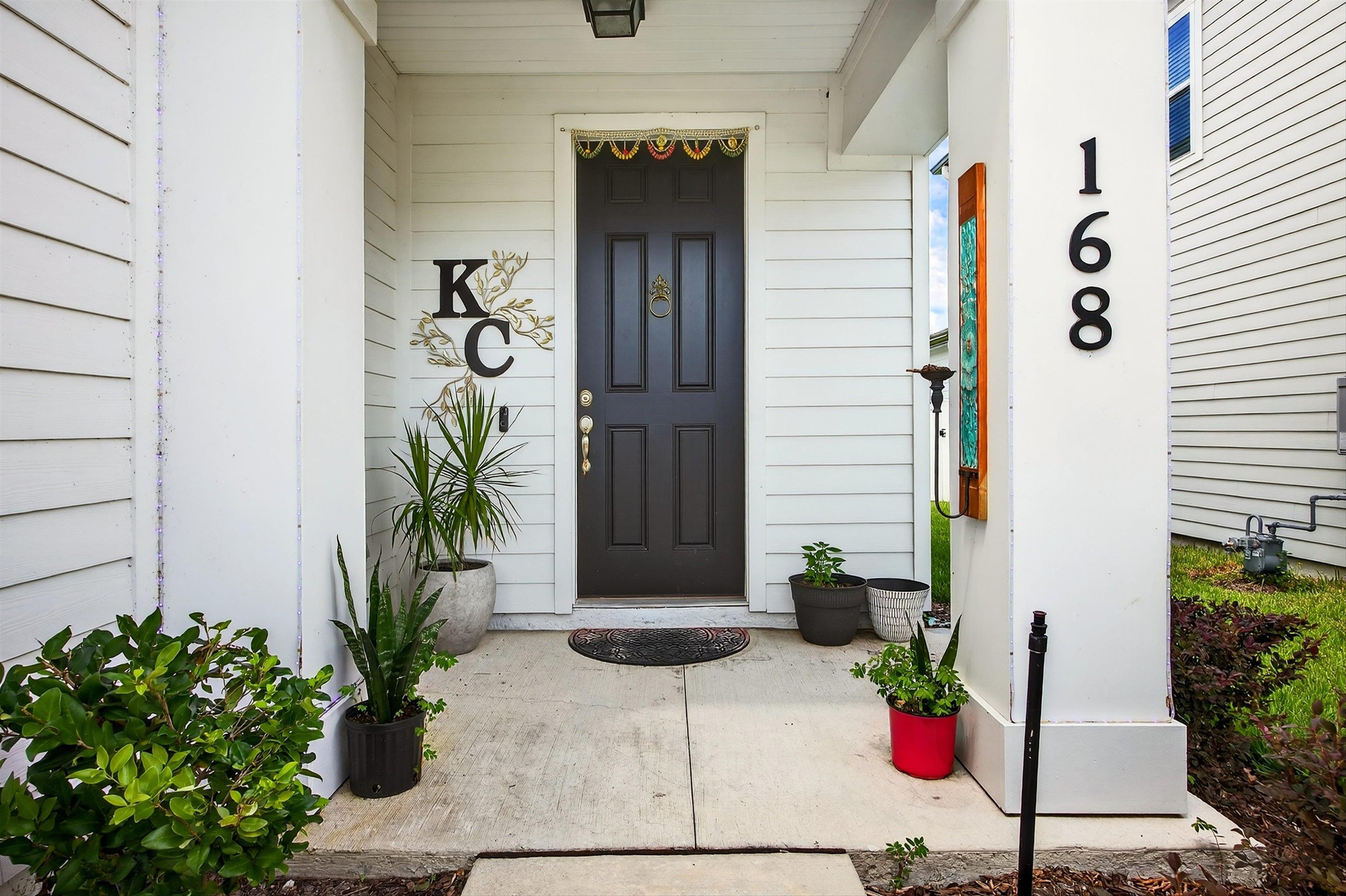 168 Torres Trace St. Augustine, FL 32095 - Photo 4 of 51 a potted plant sitting in front of a door