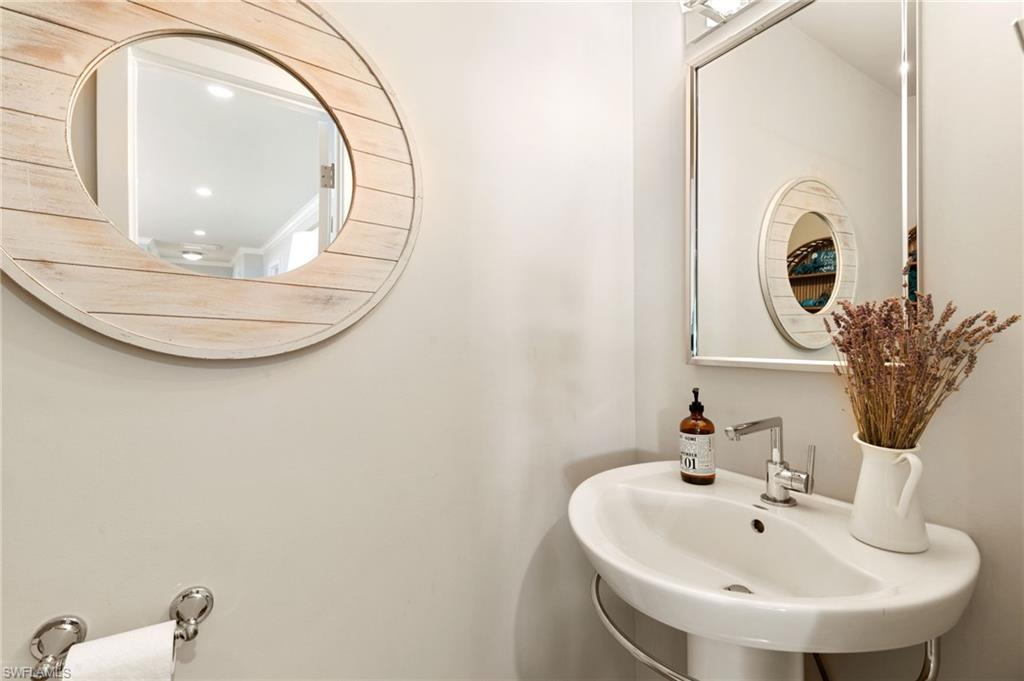 2140 Shad Court Naples, FL 34102 - Photo 34 of 44 a bathroom with a sink and mirror
