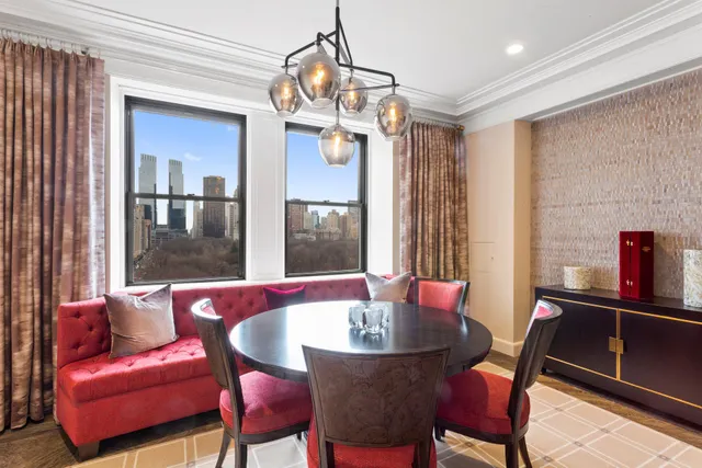 a dining room with furniture a chandelier and window