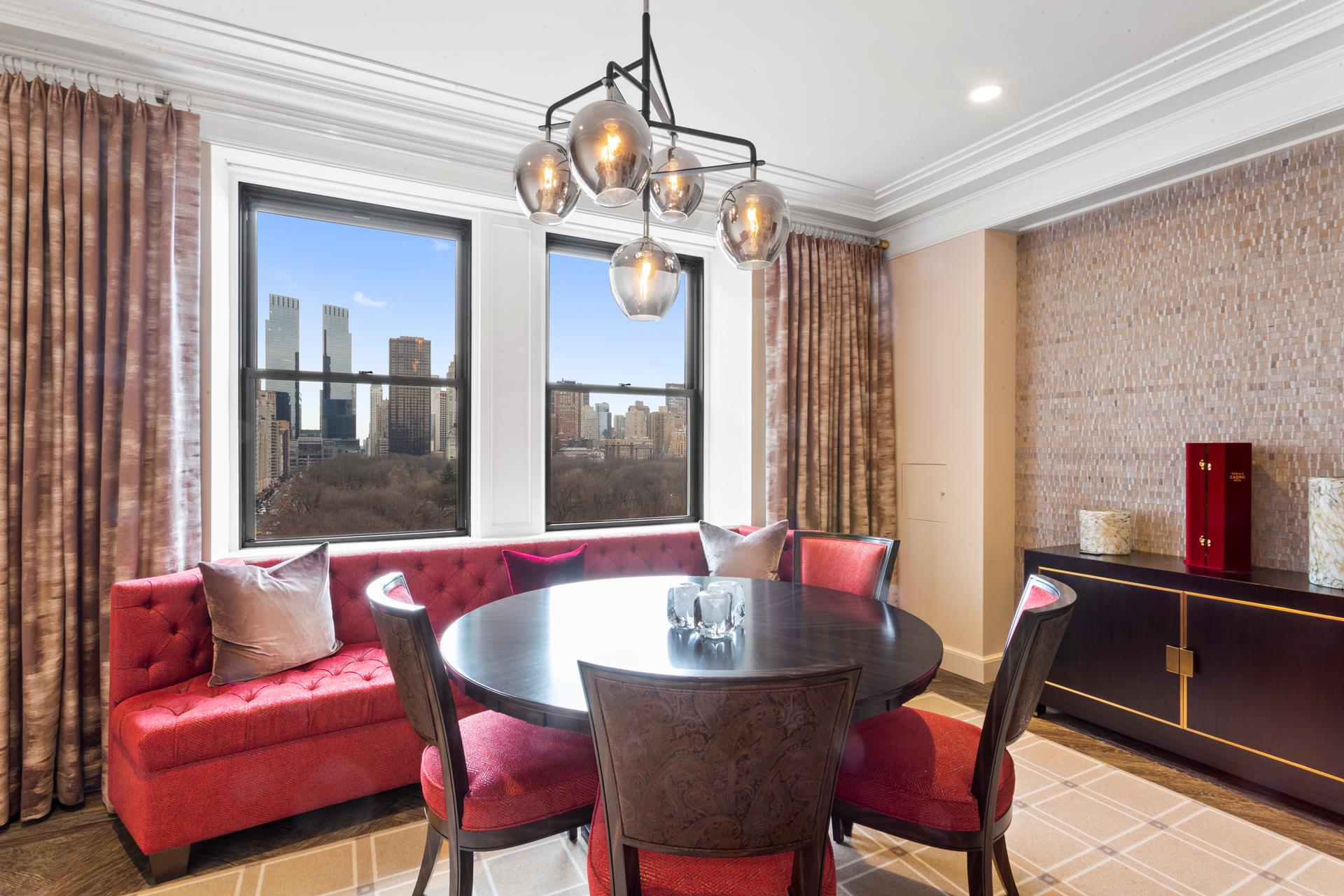 781 5th Avenue, Unit 1101 Manhattan, NY 10022 - Photo 3 of 10 a dining room with furniture a chandelier and window