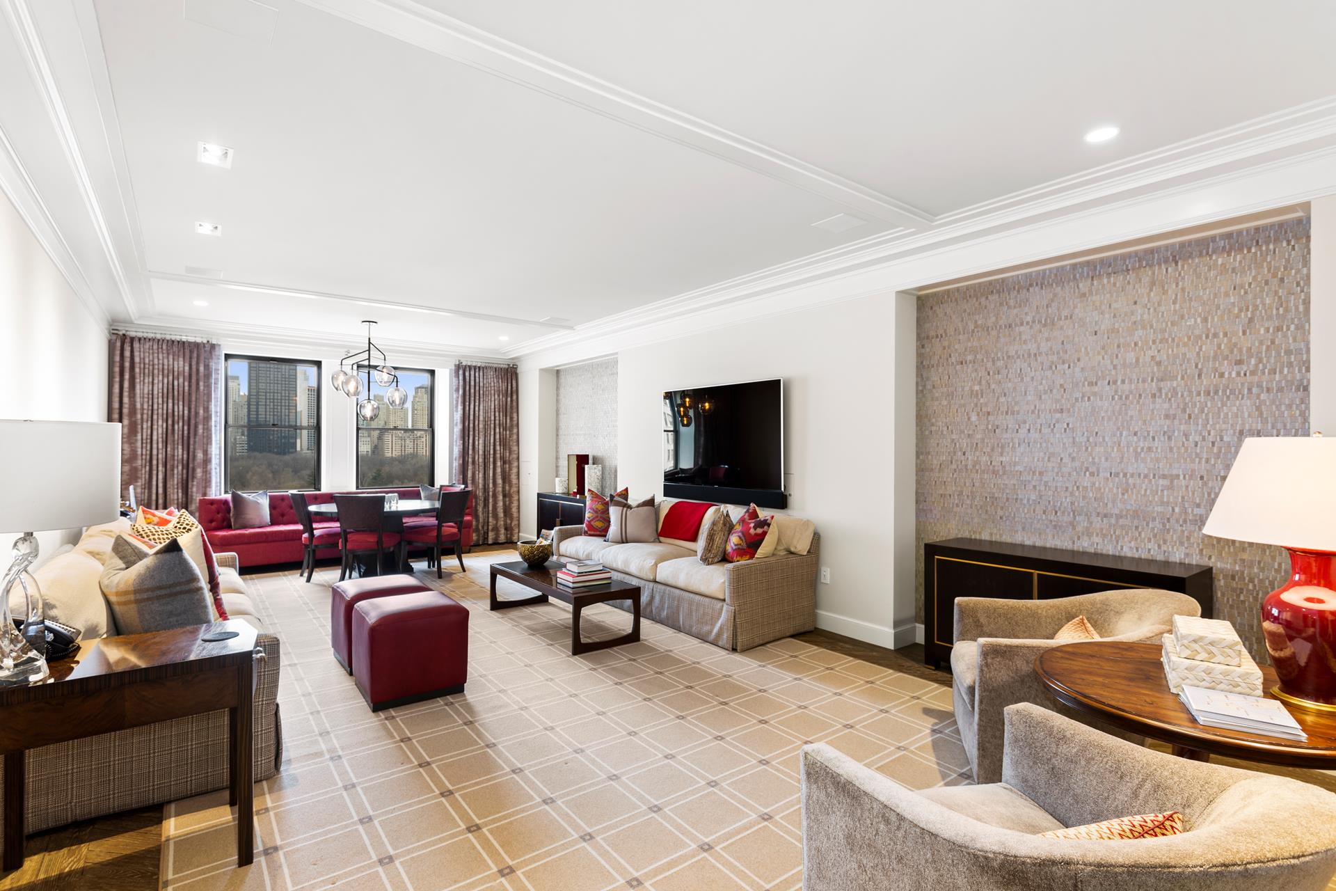 781 5th Avenue, Unit 1101 Manhattan, NY 10022 - Photo 4 of 10 a living room with furniture and a flat screen tv