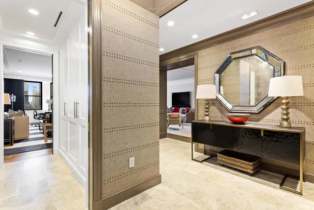 a living room with furniture a mirror and a table