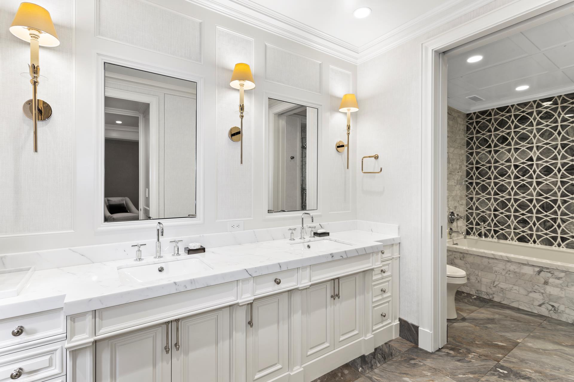 781 5th Avenue, Unit 1101 Manhattan, NY 10022 - Photo 7 of 10 a bathroom with a double vanity sink mirror and double
