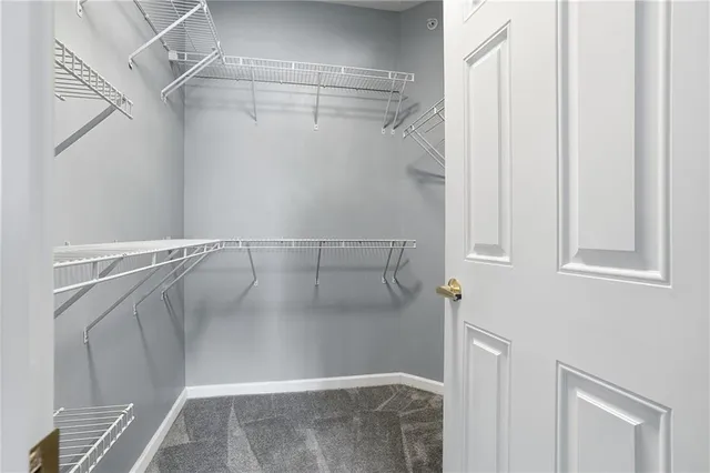 a bathroom with a granite countertop toilet a sink and a mirror