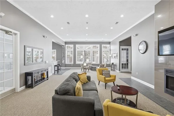 a large kitchen with lots of furniture and stainless steel appliances