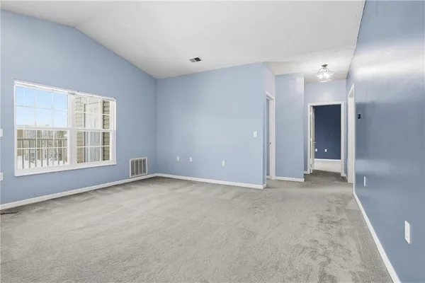 a view of empty room with a fireplace