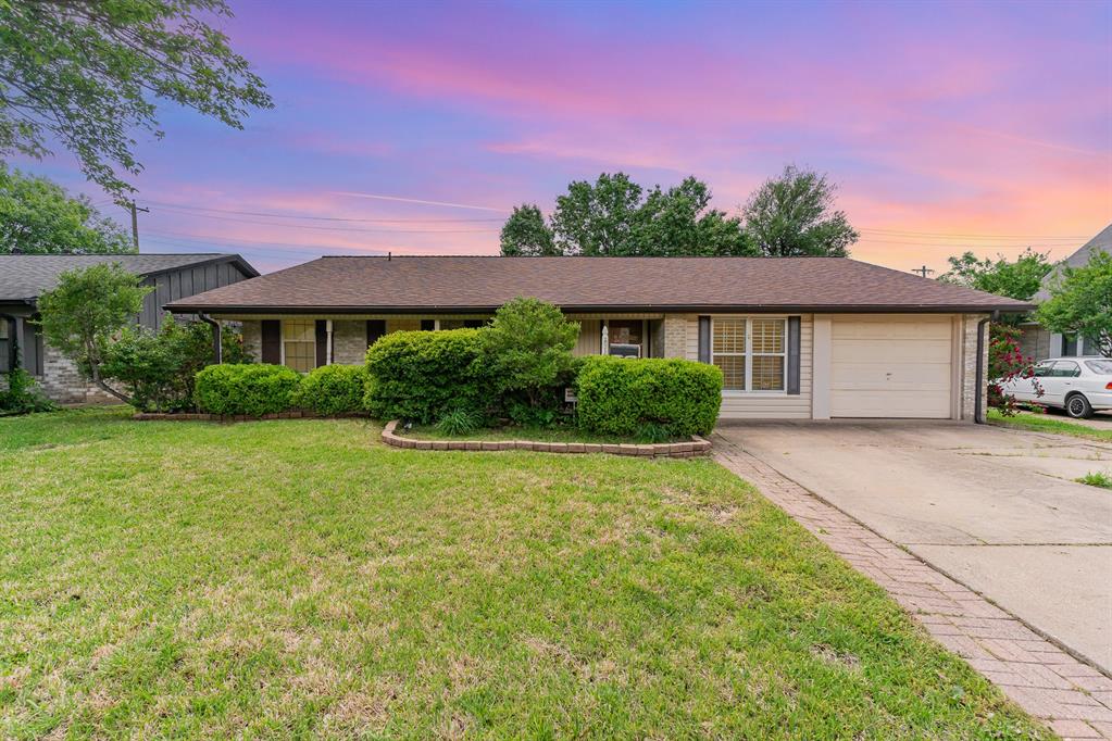 1506 McHam Street Irving, TX 75062 - Photo 1 of 1 a front view of a house with a yard and garage