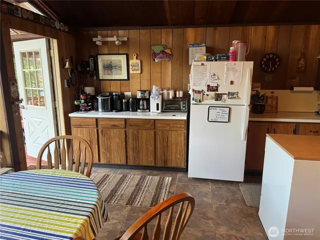 a kitchen that has a sink and a stove with a dining table