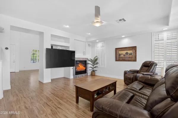 a living room with furniture a flat screen tv and a fireplace