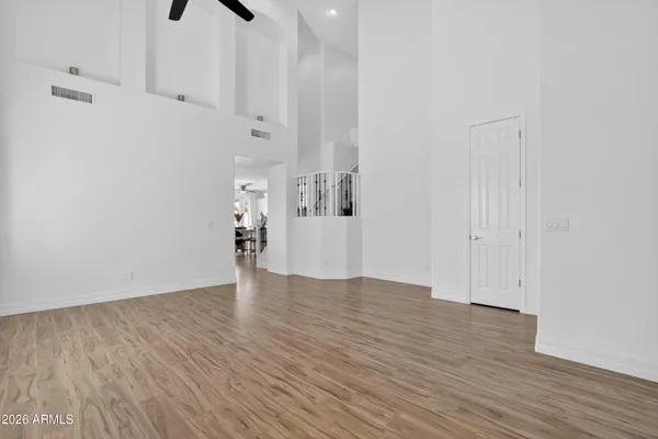 a bedroom with a bed and a ceiling fan