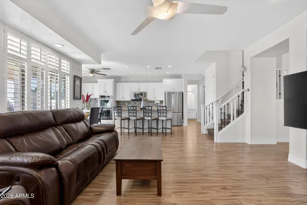 a living room with furniture a flat screen tv and a fireplace