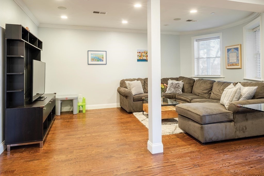 177 Winthrop Road, Unit 1 Brookline, MA 02445 - Photo 3 of 9 a living room with furniture and a flat screen tv