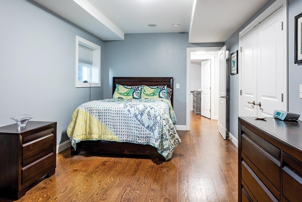 177 Winthrop Road, Unit 1 Brookline, MA 02445 - Photo 5 of 9 a bedroom with a bed and a dresser