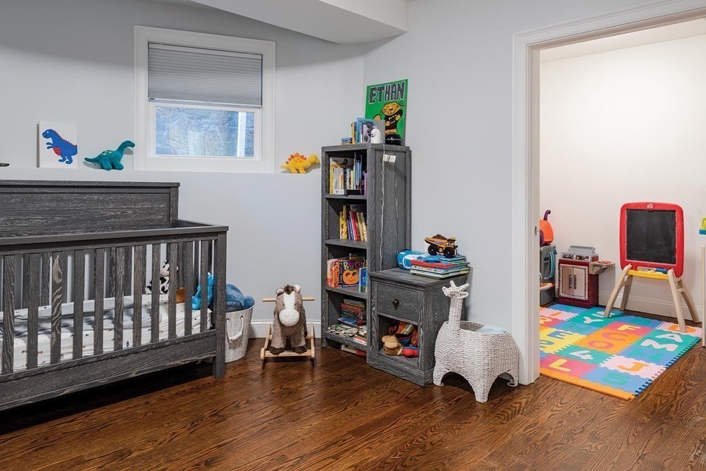 177 Winthrop Road, Unit 1 Brookline, MA 02445 - Photo 6 of 9 a bedroom with furniture and a book shelf