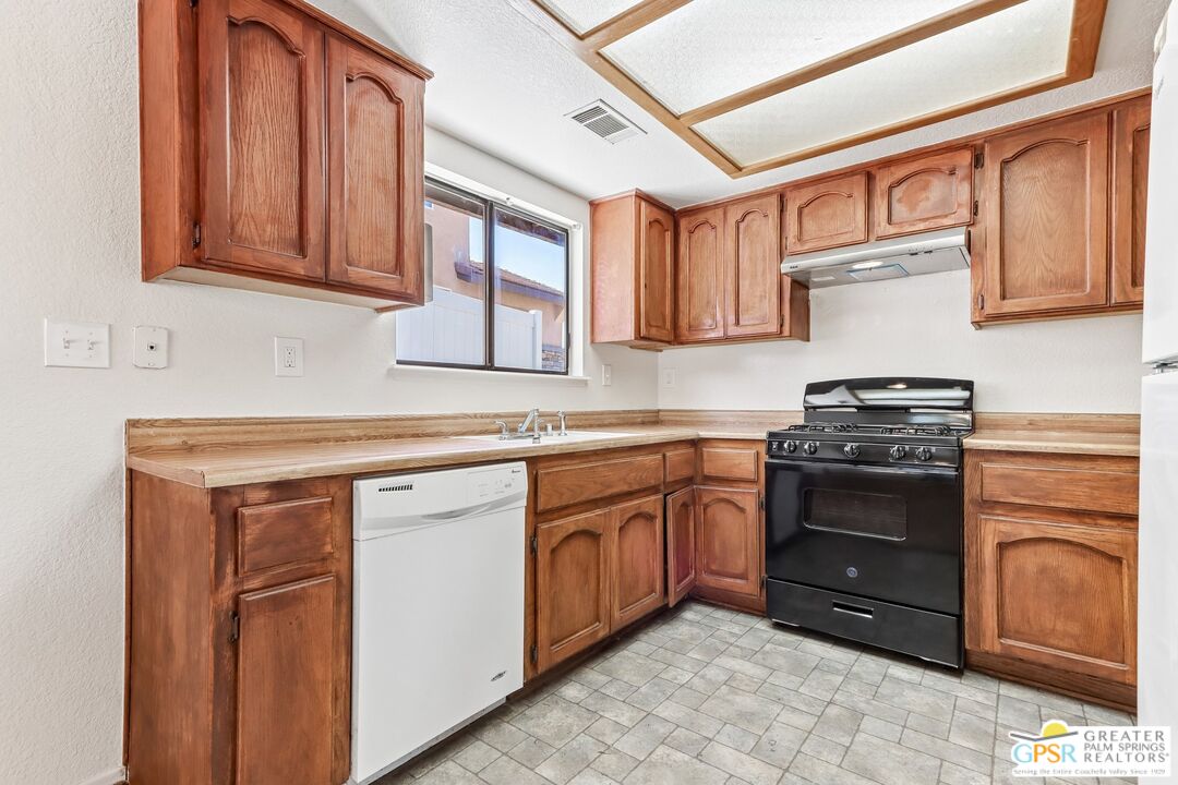 13819 Rivers Edge Road Helendale, CA 92342 - Photo 11 of 31 a kitchen with stainless steel appliances granite countertop a stove sink and cabinets