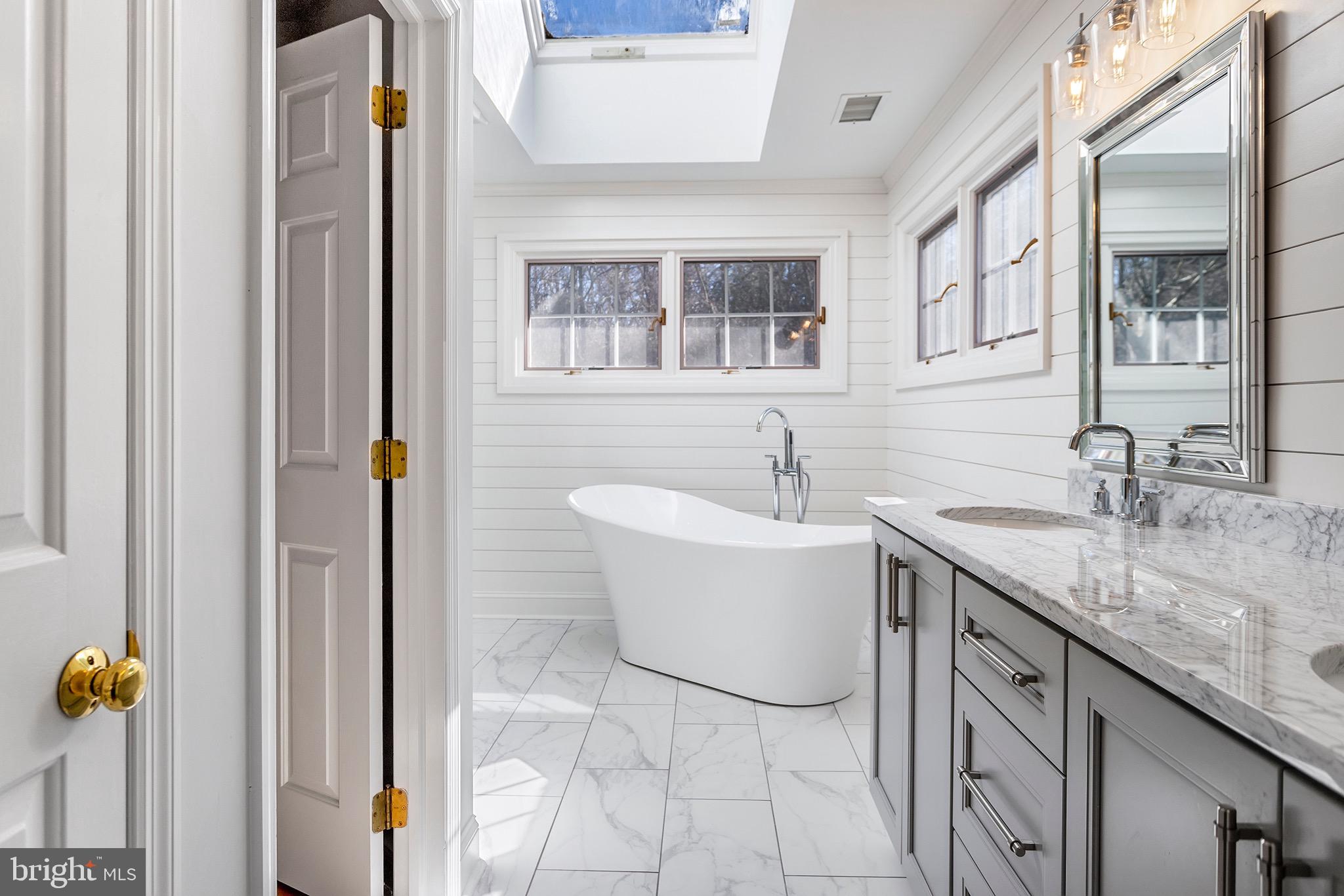 1310 Stackhouse Mill Road Newtown Square, PA 19073 - Photo 22 of 40 a bathroom with a granite countertop sink and a mirror