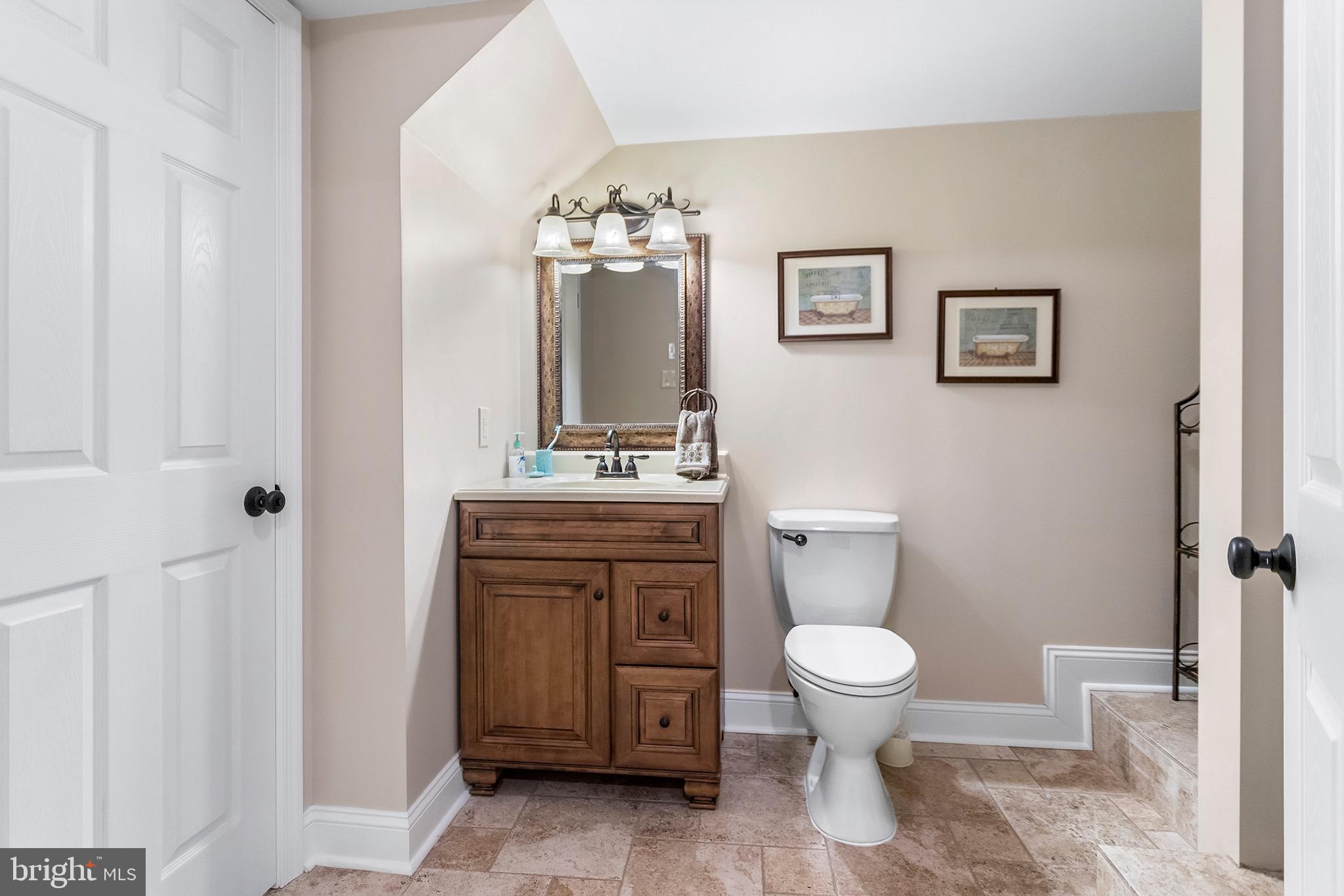 1310 Stackhouse Mill Road Newtown Square, PA 19073 - Photo 36 of 40 a bathroom with a toilet a sink and a mirror