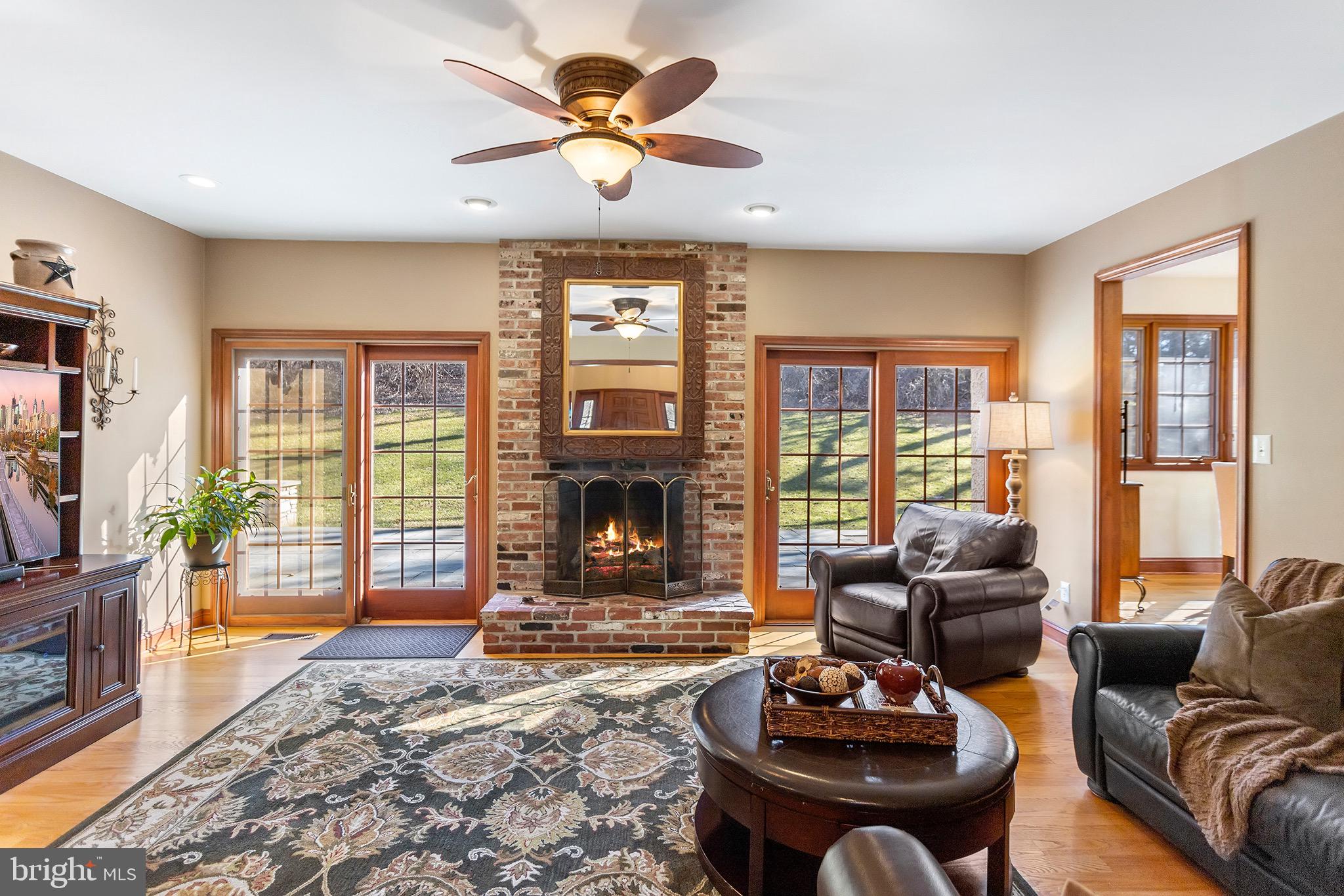 1310 Stackhouse Mill Road Newtown Square, PA 19073 - Photo 8 of 40 a living room with furniture a fireplace and a flat screen tv