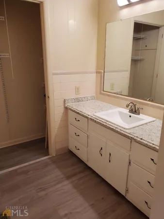a bathroom with a granite countertop sink and mirror