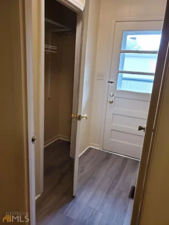 a view of a hallway with wooden floor