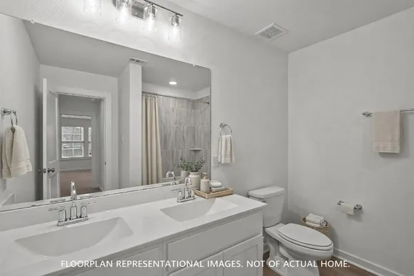 a bathroom with a shower and a glass door