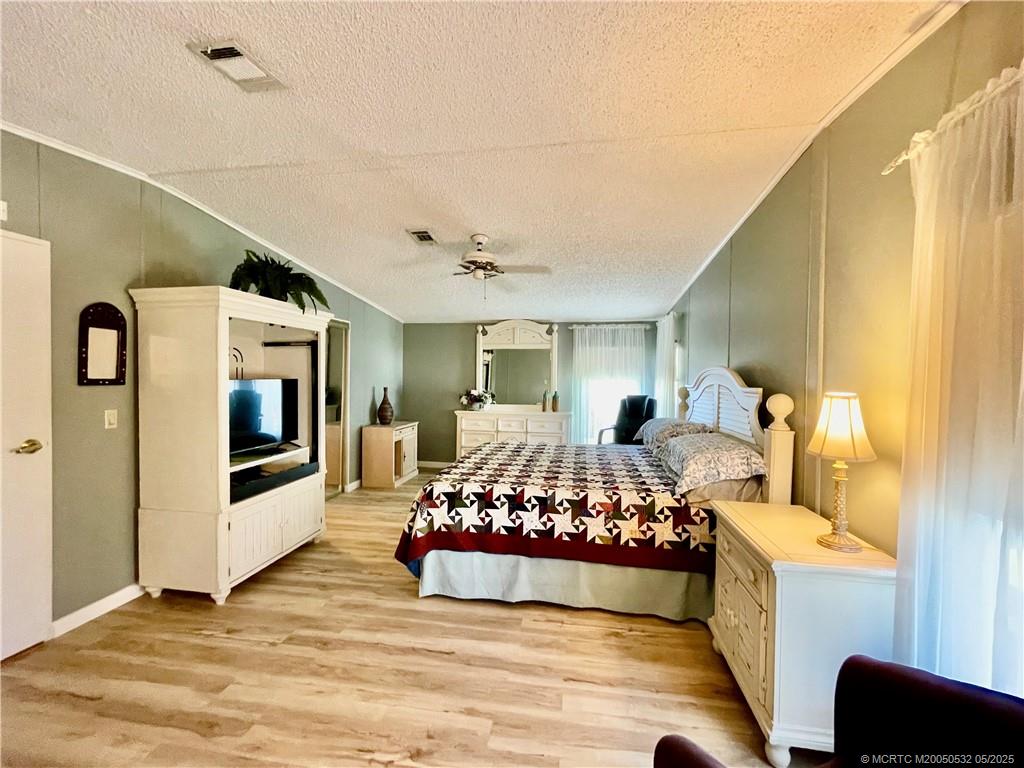 16446 Southwest Three Wood Way Indiantown, FL 34956 - Photo 16 of 32 a bedroom with furniture and window