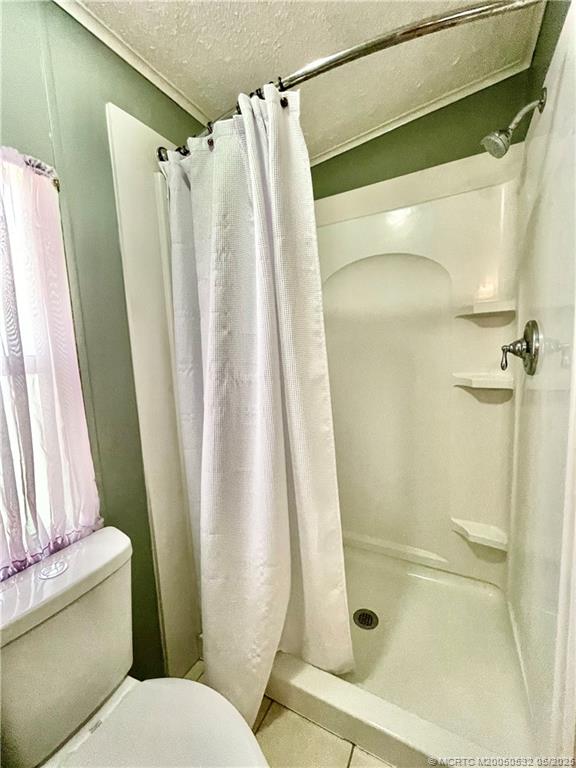 16446 Southwest Three Wood Way Indiantown, FL 34956 - Photo 19 of 32 a bathroom with a shower and a toilet