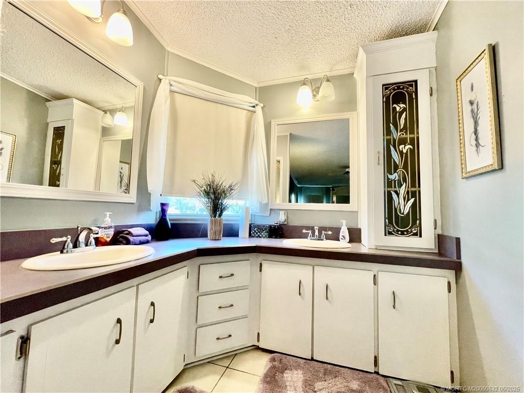 16446 Southwest Three Wood Way Indiantown, FL 34956 - Photo 20 of 32 a bathroom with a sink and a mirror