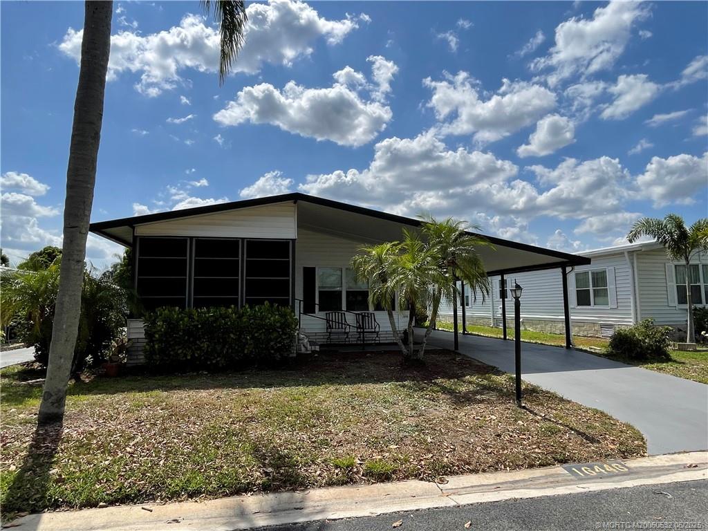 16446 Southwest Three Wood Way Indiantown, FL 34956 - Photo 2 of 32 a view of a house with a garden