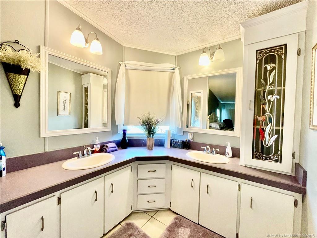 16446 Southwest Three Wood Way Indiantown, FL 34956 - Photo 21 of 32 a bathroom with a granite countertop sink mirror and