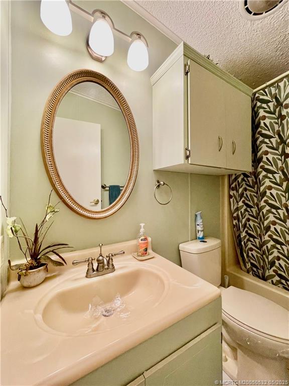 16446 Southwest Three Wood Way Indiantown, FL 34956 - Photo 25 of 32 a bathroom with a toilet a sink and a mirror
