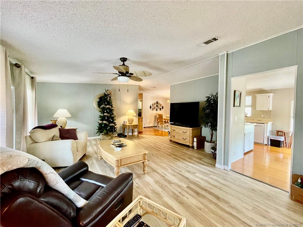 16446 Southwest Three Wood Way Indiantown, FL 34956 - Photo 27 of 32 a living room with furniture and a flat screen tv