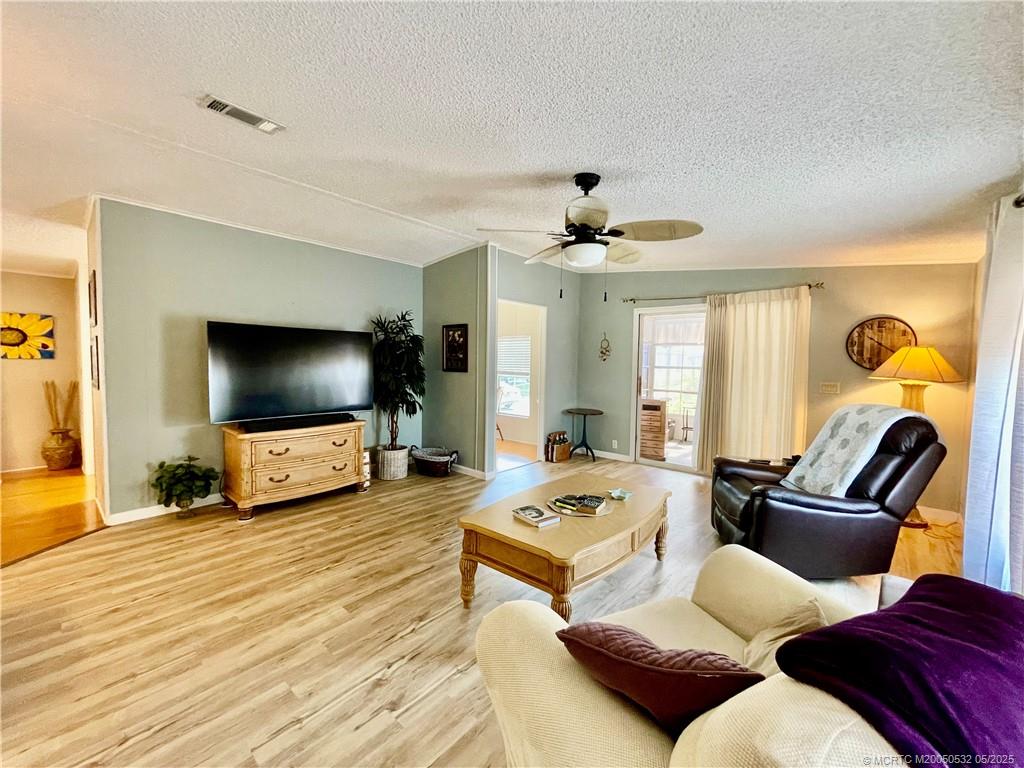 16446 Southwest Three Wood Way Indiantown, FL 34956 - Photo 28 of 32 a living room with furniture and a flat screen tv