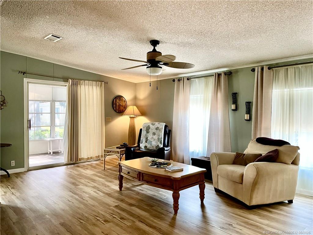16446 Southwest Three Wood Way Indiantown, FL 34956 - Photo 29 of 32 a living room with furniture and wooden floor