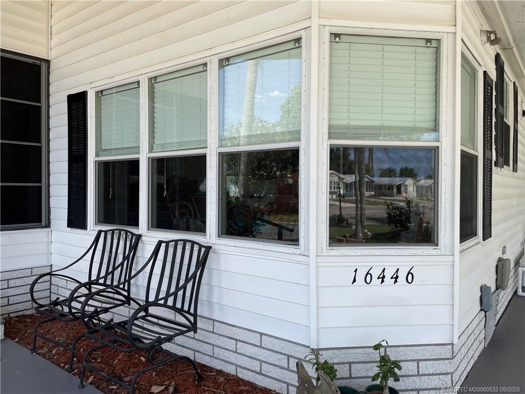 16446 Southwest Three Wood Way Indiantown, FL 34956 - Photo 3 of 32 a view of a door with a balcony