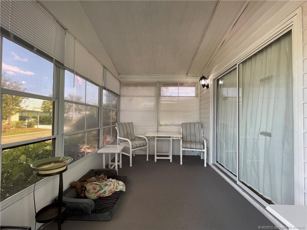 16446 Southwest Three Wood Way Indiantown, FL 34956 - Photo 6 of 32 a room with gym equipment and large window