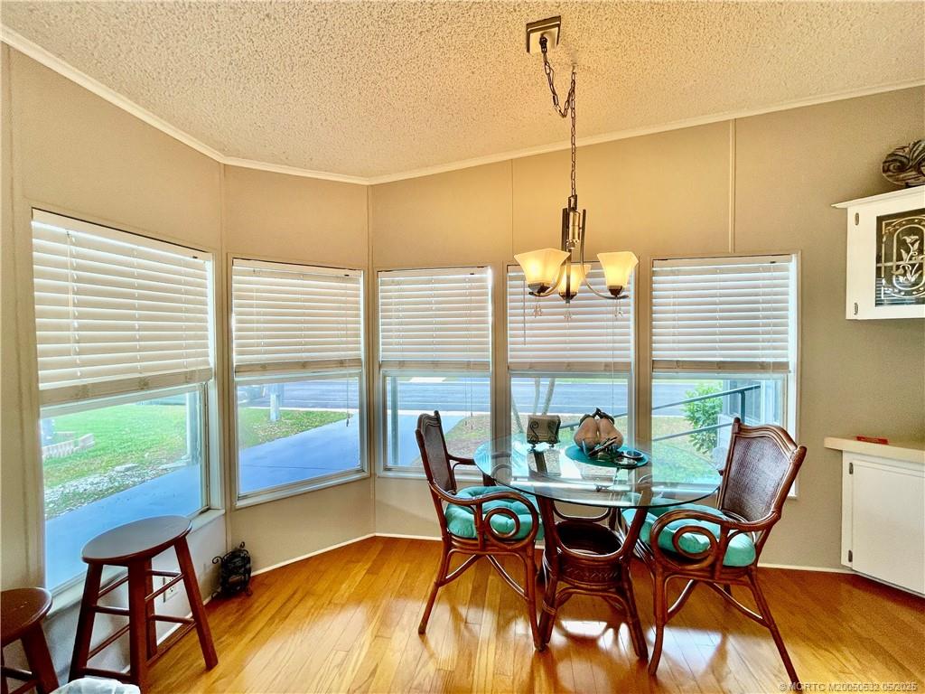 16446 Southwest Three Wood Way Indiantown, FL 34956 - Photo 9 of 32 a view of a dining room with furniture window and outside view