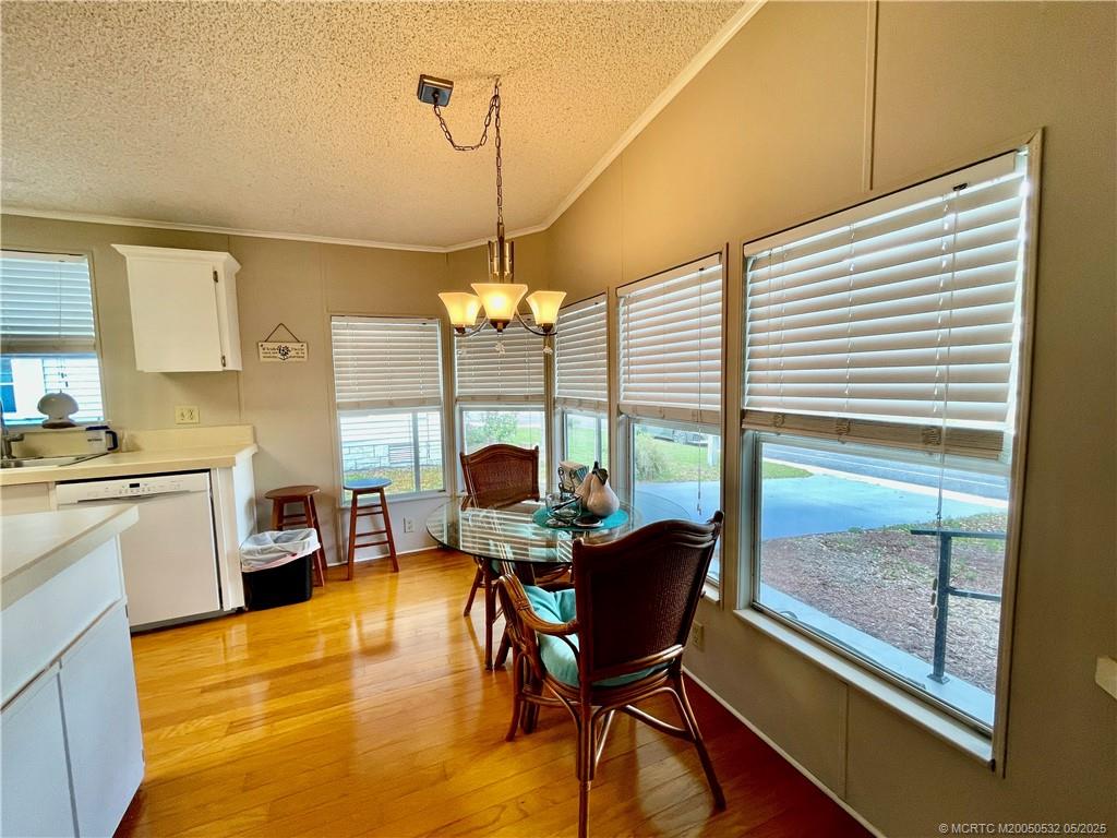 16446 Southwest Three Wood Way Indiantown, FL 34956 - Photo 10 of 32 a view of a dining room with furniture window and wooden floor