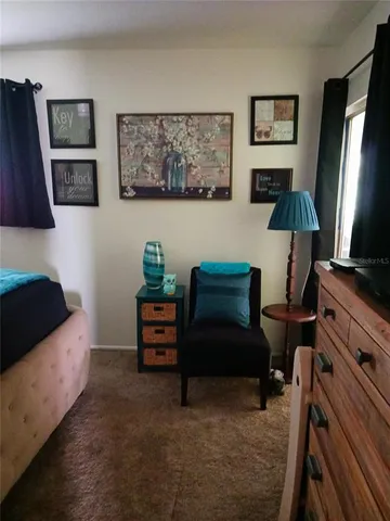 a bedroom with furniture and a flat screen tv