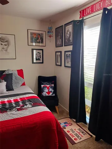 a bedroom with a bed and a dresser in it