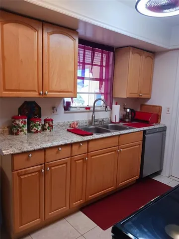 a kitchen with stainless steel appliances granite countertop wooden cabinets a sink and dishwasher