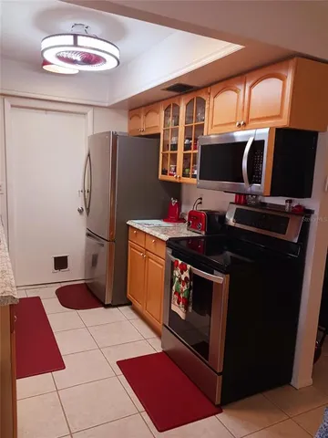 a kitchen with stainless steel appliances granite countertop a refrigerator stove and sink