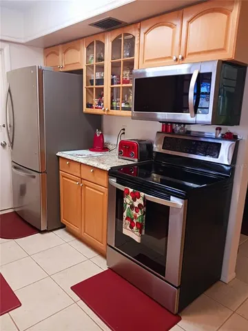 a kitchen with stainless steel appliances a stove and a refrigerator