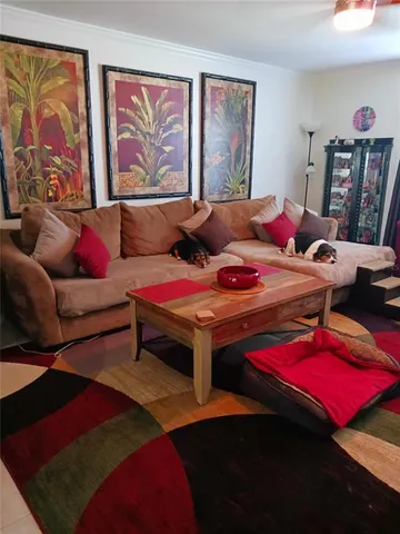 a living room with furniture and painting on the wall